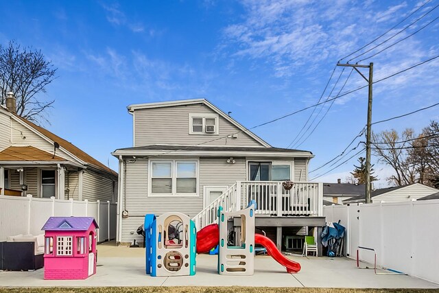 7715 W Patterson Ave, Chicago, IL 60634 - back of house with a fenced backyard, a playground, and a deck
