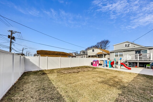 7715 W Patterson Ave, Chicago, IL 60634 - view of yard featuring a playground and a wooden deck