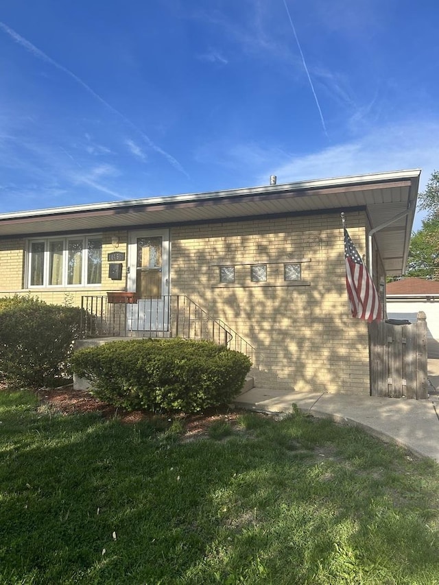 14453 Kildare Ave, Midlothian, IL 60445 - view of property exterior with brick siding and a lawn