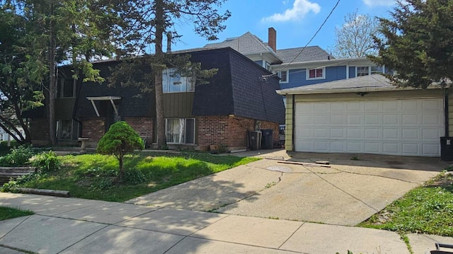 422 Ryerson Ave, Elgin, IL 60123 - view of front facade featuring brick siding, a garage, and driveway