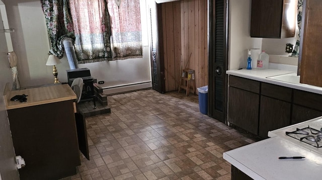 422 Ryerson Ave, Elgin, IL 60123 - bathroom with baseboard heating, brick patterned flooring, and a wood stove