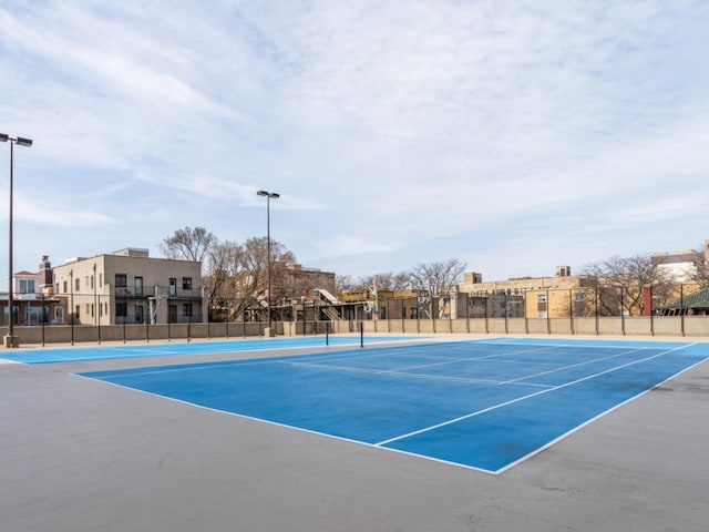 view of tennis court with fence