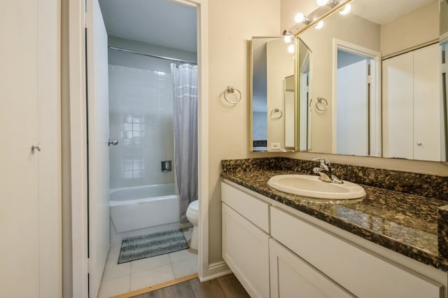 full bath with toilet, vanity, shower / bath combo, and wood finished floors