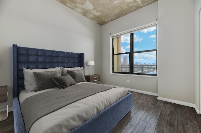 bedroom featuring wood finished floors and baseboards