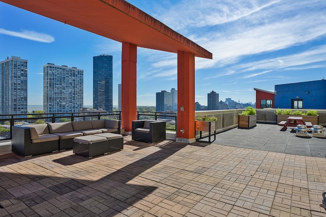 view of patio / terrace featuring a view of skyline and an outdoor living space