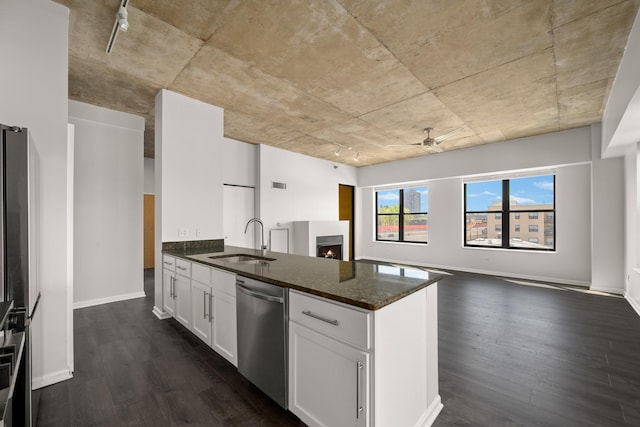 kitchen with dishwasher, a sink, ceiling fan, and dark wood-style floors