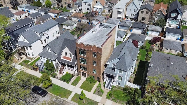 aerial view of property and surrounding area featuring nearby suburban area