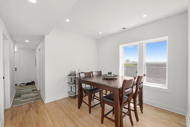 dining room featuring baseboards, light wood-style floors, and recessed lighting