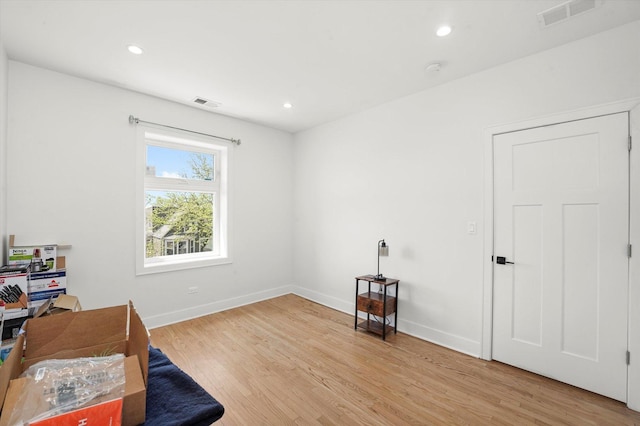 home office featuring light wood finished floors, baseboards, and recessed lighting