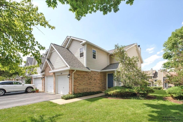319 E Theodore Ln, Itasca, IL 60143 - view of front of home with brick siding, driveway, a garage, a front lawn, and a shingled roof