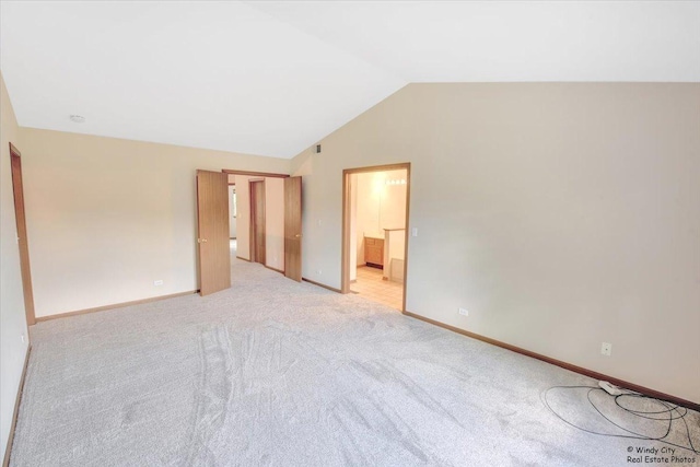 319 E Theodore Ln, Itasca, IL 60143 - unfurnished bedroom with vaulted ceiling, light colored carpet, and connected bathroom