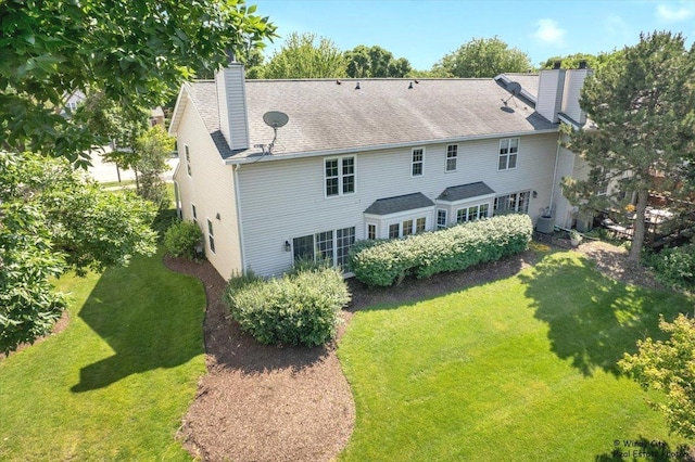 319 E Theodore Ln, Itasca, IL 60143 - back of house featuring a chimney and a yard