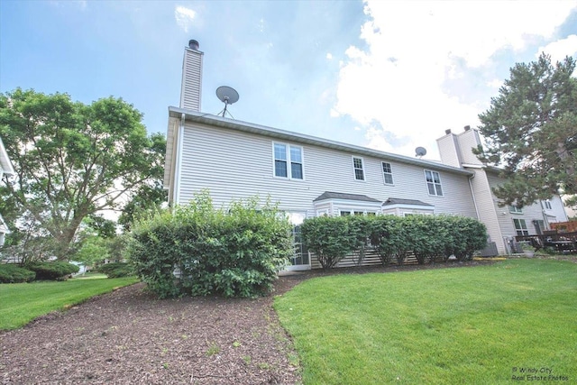319 E Theodore Ln, Itasca, IL 60143 - back of house with a lawn and a chimney