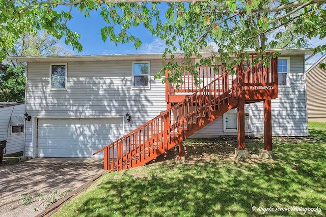 5305 N Highland Dr, Mchenry, IL 60050 - back of property with an attached garage, stairway, driveway, a deck, and a lawn