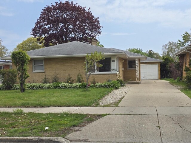ranch-style house with brick siding, an attached garage, driveway, a front yard, and a chimney
