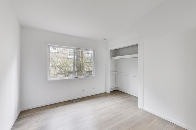 523 Green Bay Rd, Highland Park, IL 60035 - unfurnished bedroom with wood finished floors, a closet, and baseboards