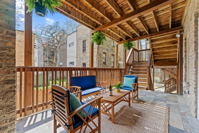 view of patio / terrace with stairs and an outdoor living space