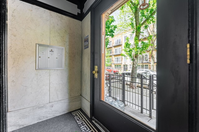 doorway to outside with mail area
