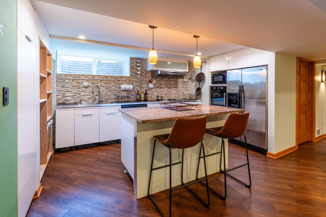 4610 Main St, Lisle, IL 60532 - kitchen with black appliances, a sink, decorative backsplash, a center island, and white cabinets