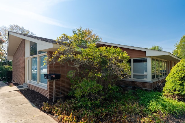 4610 Main St, Lisle, IL 60532 - view of side of property with brick siding and a sunroom