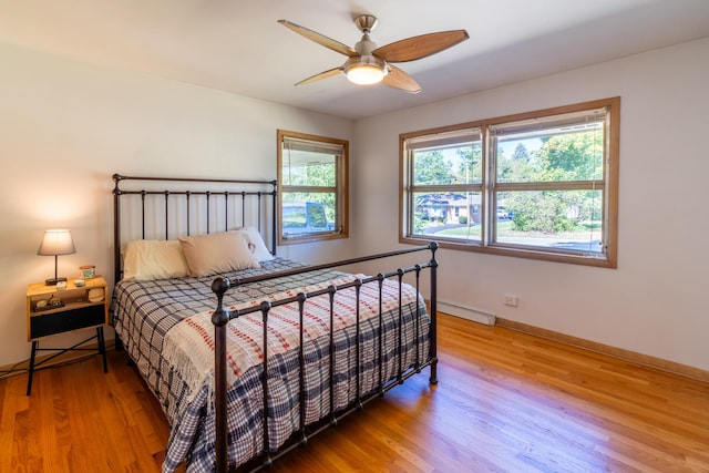 4610 Main St, Lisle, IL 60532 - bedroom featuring light wood-type flooring, baseboards, ceiling fan, and baseboard heating
