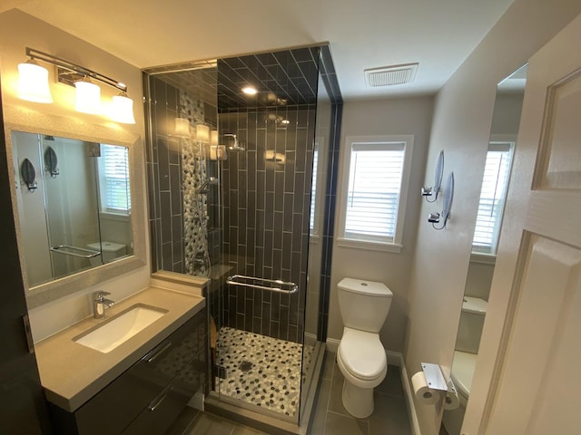 full bathroom with toilet, a shower stall, vanity, and tile patterned floors