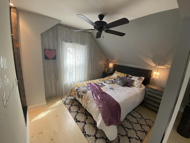bedroom with lofted ceiling, wood finished floors, and ceiling fan