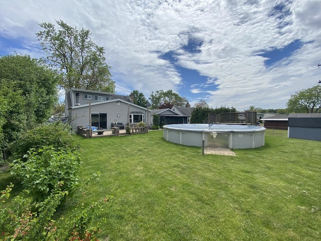 view of green lawn featuring a wooden deck