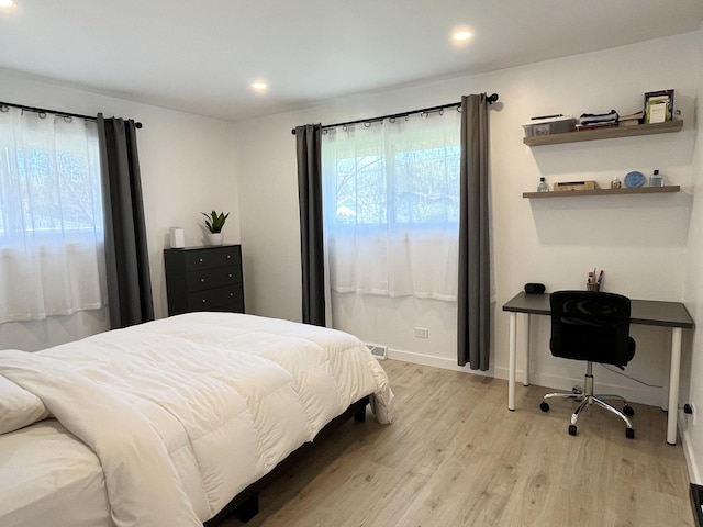 bedroom with multiple windows, light wood-style floors, recessed lighting, and baseboards
