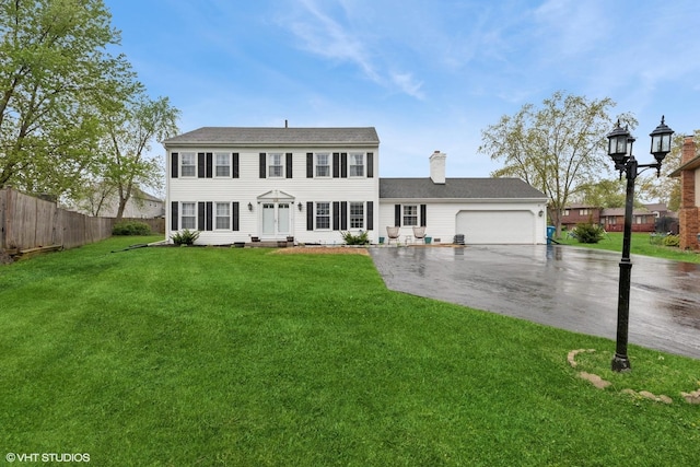 25 E Donovan Ct, Crete, IL 60417 - colonial-style house featuring asphalt driveway, an attached garage, a chimney, and entry steps