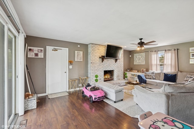 25 E Donovan Ct, Crete, IL 60417 - living room with wood finished floors, a brick fireplace, ceiling fan, and baseboards