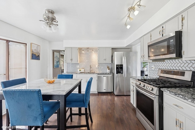25 E Donovan Ct, Crete, IL 60417 - kitchen featuring appliances with stainless steel finishes, decorative backsplash, a sink, and light stone counters