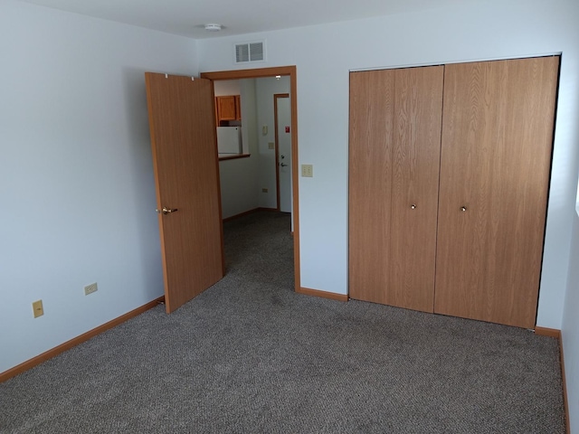 unfurnished bedroom featuring carpet flooring, a closet, and baseboards