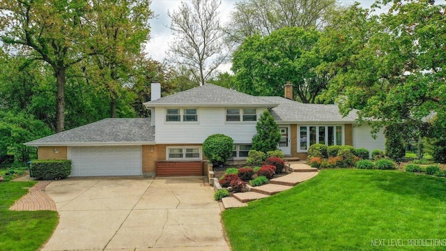 2663 Southcrest Dr, Downers Grove, IL 60516 - split level home featuring a chimney, a garage, concrete driveway, and a front lawn