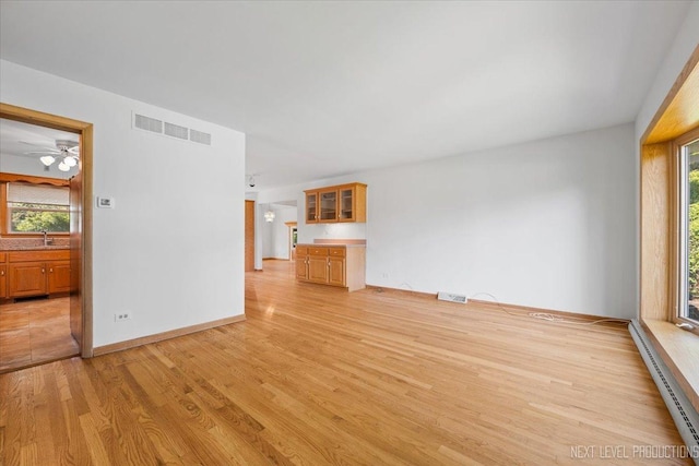 2663 Southcrest Dr, Downers Grove, IL 60516 - unfurnished living room with light wood-type flooring, plenty of natural light, a sink, and ceiling fan
