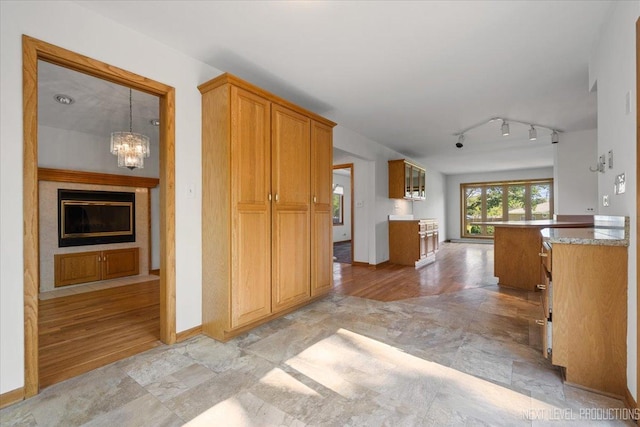 2663 Southcrest Dr, Downers Grove, IL 60516 - kitchen with a chandelier, brown cabinetry, and track lighting