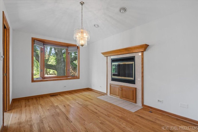 2663 Southcrest Dr, Downers Grove, IL 60516 - unfurnished living room with a chandelier, light wood-type flooring, and baseboards