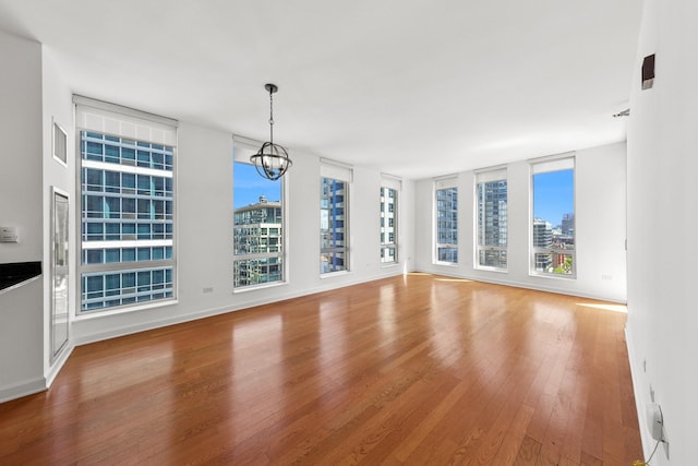 1250 S Michigan Ave Unit 1502, Chicago, IL 60605 - unfurnished dining area featuring wood finished floors and a chandelier