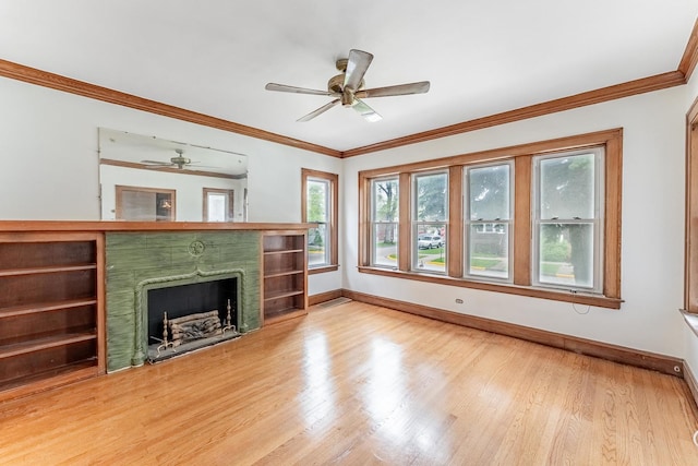 unfurnished living room featuring a fireplace, baseboards, wood finished floors, a ceiling fan, and ornamental molding