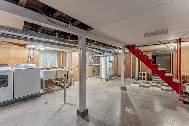 unfinished basement featuring washer and clothes dryer and stairs