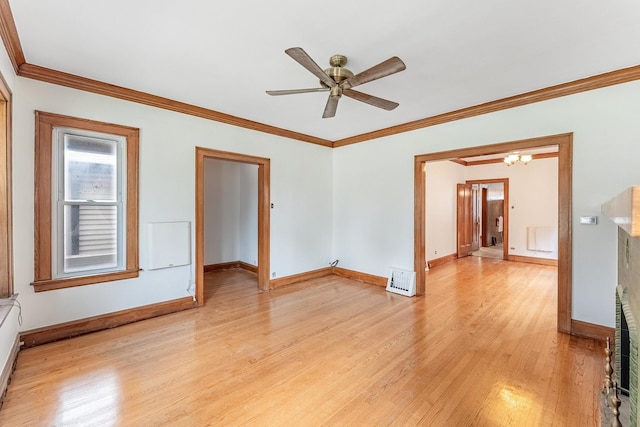 spare room featuring light wood finished floors, baseboards, ornamental molding, ceiling fan, and a chandelier