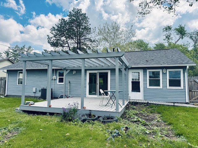 rear view of property featuring a pergola, a deck, a shingled roof, and central AC unit