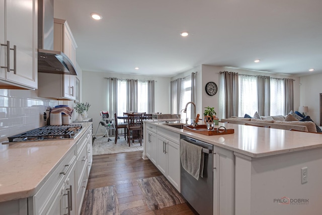 1027 Button Bush St, South Elgin, IL 60177 - kitchen featuring appliances with stainless steel finishes, a sink, wall chimney exhaust hood, an island with sink, and recessed lighting