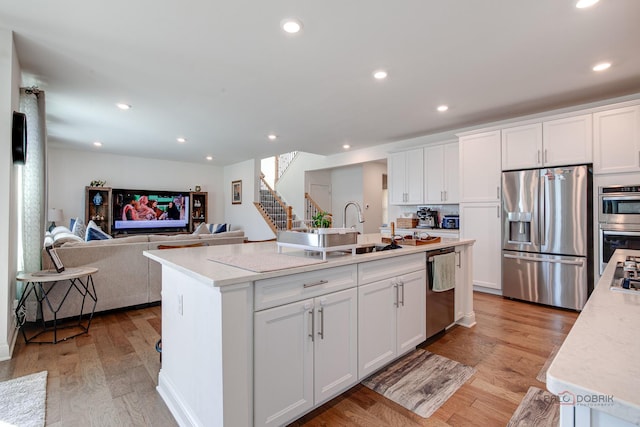 1027 Button Bush St, South Elgin, IL 60177 - kitchen with appliances with stainless steel finishes, a sink, white cabinets, a kitchen island with sink, and recessed lighting