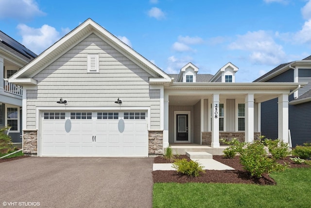 2508 Weatherbee Ln, Naperville, IL 60563 - view of front of house with stone siding, asphalt driveway, covered porch, and an attached garage