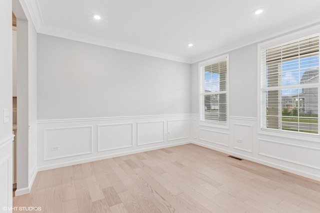 2508 Weatherbee Ln, Naperville, IL 60563 - empty room featuring light wood-style flooring, ornamental molding, a wainscoted wall, recessed lighting, and a decorative wall