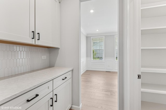2508 Weatherbee Ln, Naperville, IL 60563 - bar area with ornamental molding, tasteful backsplash, wainscoting, and light wood finished floors