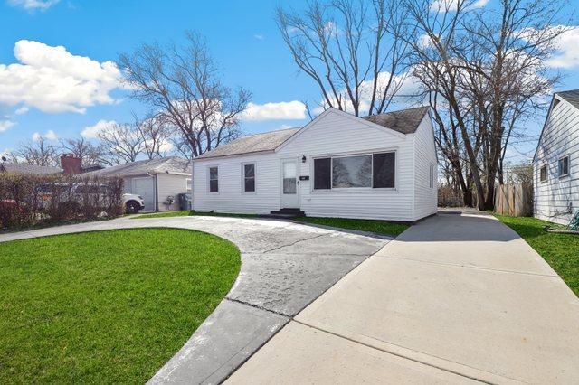 292 W 17th St, Chicago Heights, IL 60411 - view of front of property featuring curved driveway, a front yard, and entry steps