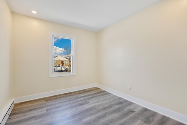 292 W 17th St, Chicago Heights, IL 60411 - unfurnished room featuring a baseboard heating unit, wood finished floors, baseboards, and recessed lighting