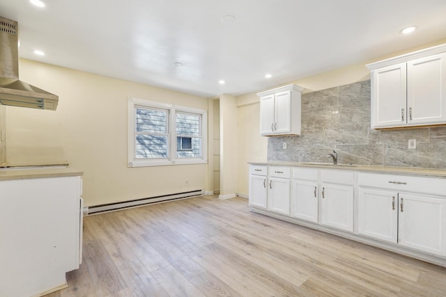 292 W 17th St, Chicago Heights, IL 60411 - kitchen featuring a baseboard radiator, wall chimney range hood, backsplash, light countertops, and light wood-type flooring